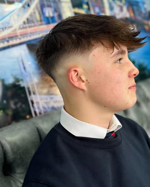A clean skin fade with a longer swept top