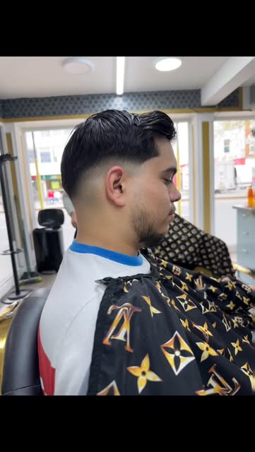 Styled dark hair, close fade and shaped beard